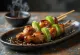 Negima yakitori kyckling och salladslök på spett, serverad med sesamfrön och färsk salladslök